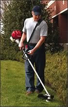 Man trimming weeds with a Honda Trimmer